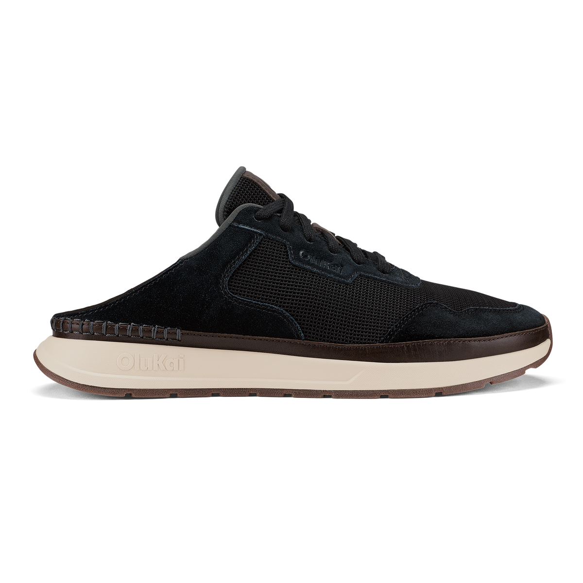 Black slip-on sneaker with mesh and suede upper, cream midsole, and brown trim detail.