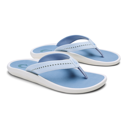 Pair of blue and white thong sandals with studded straps and cushioned soles.