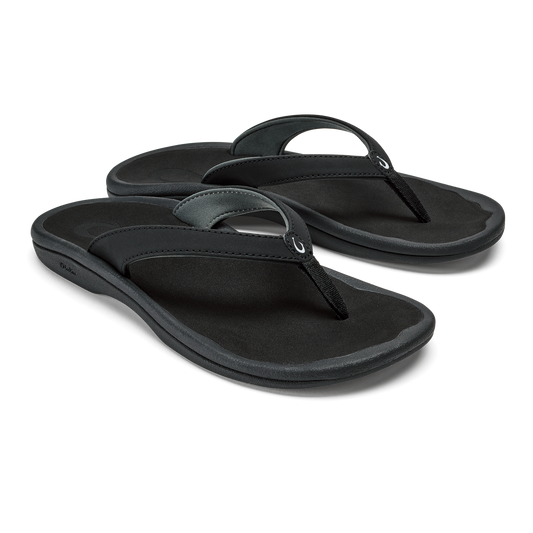 Pair of black thong sandals with cushioned soles and dark straps against white background.