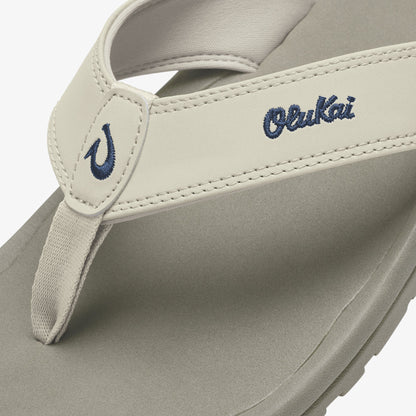 Cream-colored thong sandal with navy embroidered "Ohana" text and curved logo detail on the upper strap.