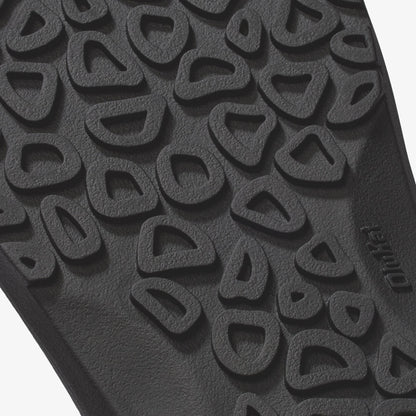 Close-up of textured sole with repeating curved geometric pattern and "native" branding.