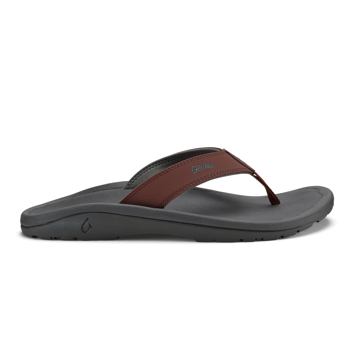 Flip-flop with gray foam sole and brown leather thong strap, side view.