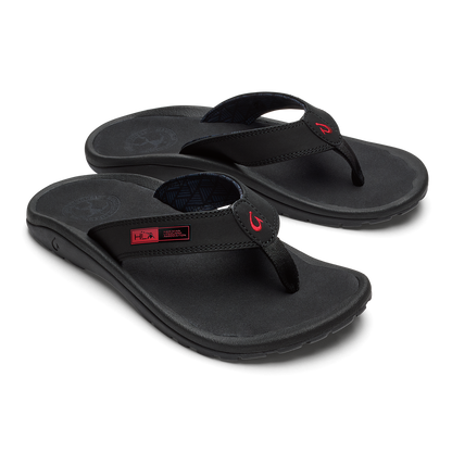 Black thong sandals with padded footbed and red accent logo on straps.