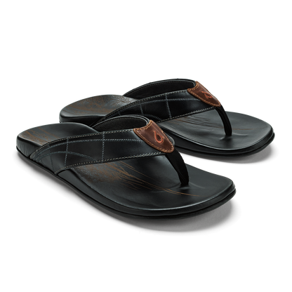Black thong sandals with brown leather toe post and white stitching detail on padded footbed.