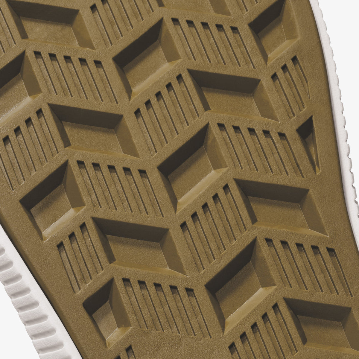 Tan and white shoe sole with geometric tread pattern featuring rectangular blocks and linear grooves.