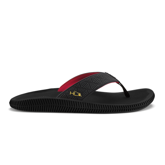 Black flip-flop sandal with red and black textured strap and geometric pattern on upper.