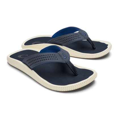 Pair of navy and blue thong sandals with cream-colored ribbed soles and perforated straps.