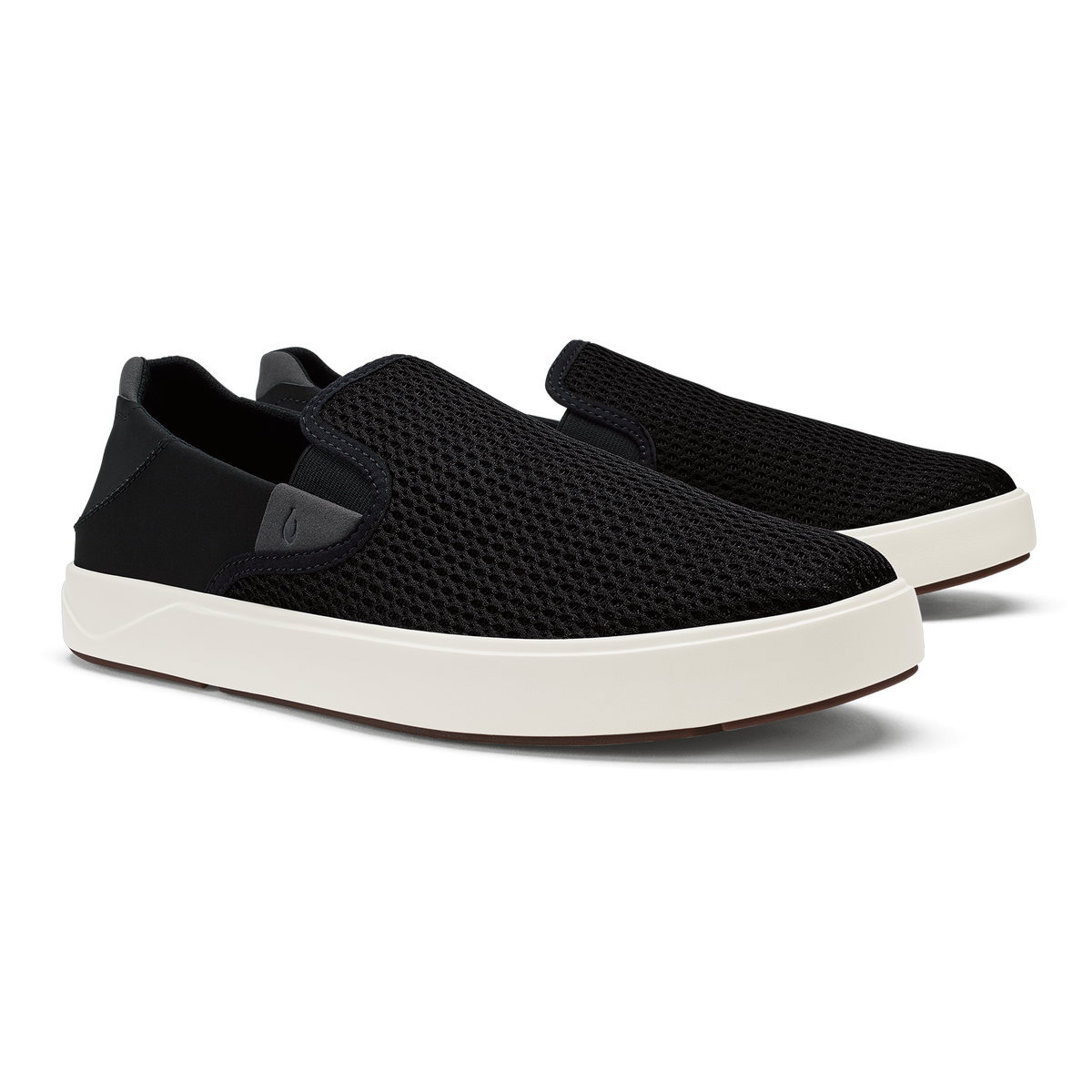 Black knit slip-on sneakers with cream-colored sole and black heel tab.