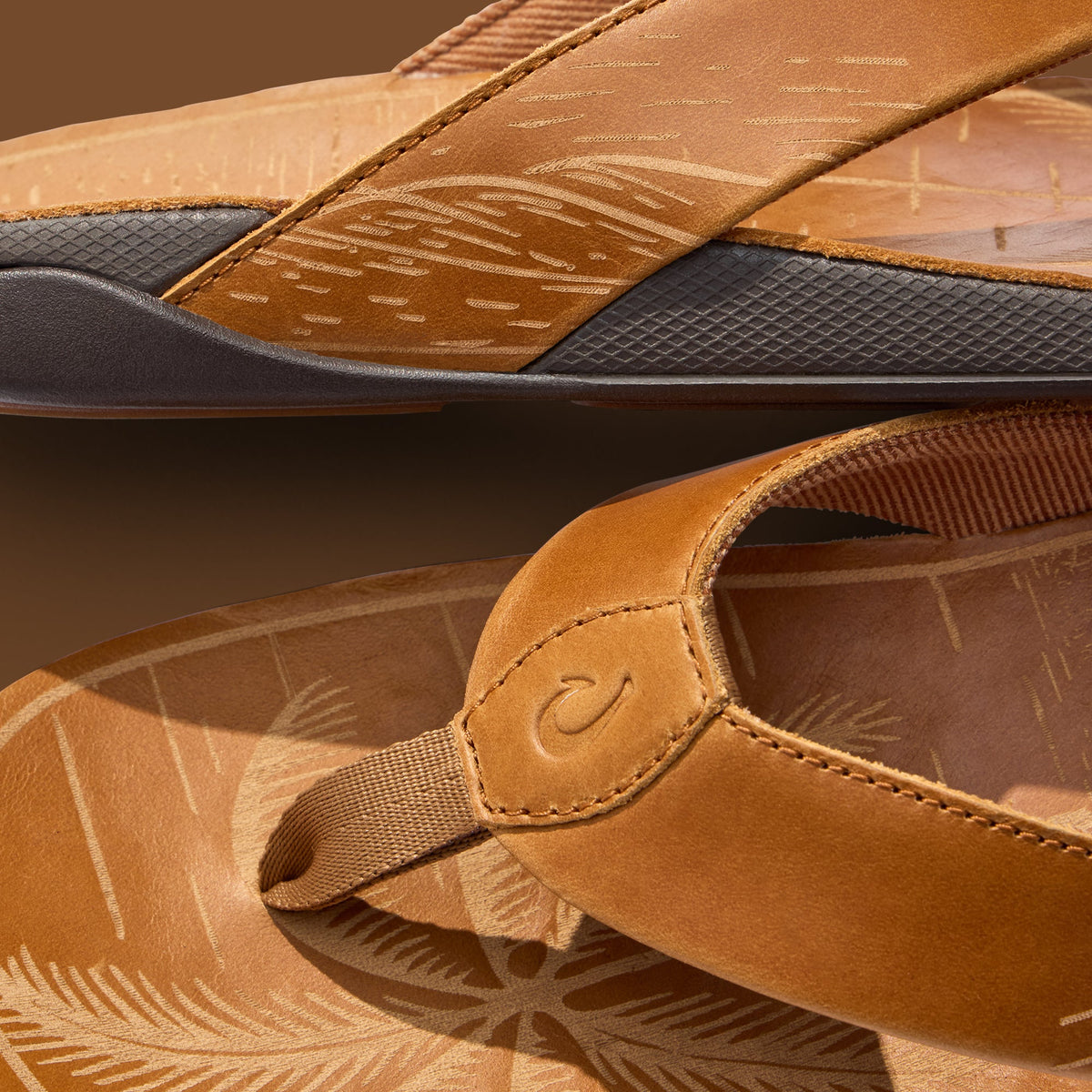 Tan leather sandals with embossed fox pattern, black sole, and tan fabric heel strap.