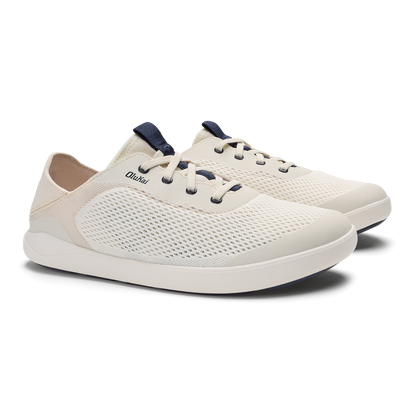 White and navy lace-up sneaker with mesh upper and white sole, shown from the side angle.