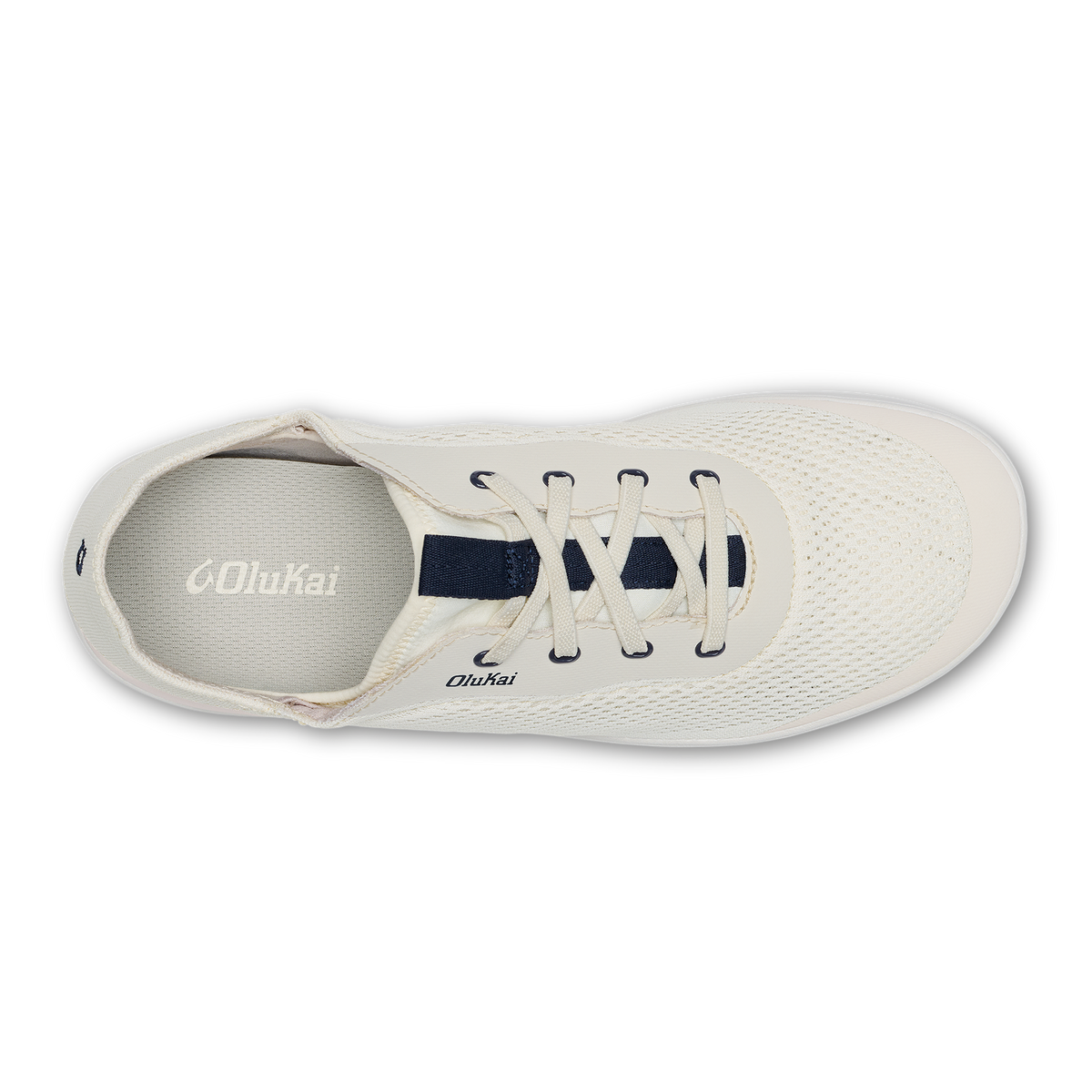 White canvas sneaker with dark blue laces and tongue, viewed from above showing perforated upper and Olukai branding.