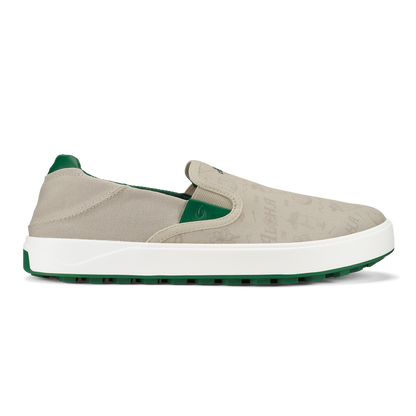 Beige canvas slip-on sneaker with white midsole and green heel counter and outsole.