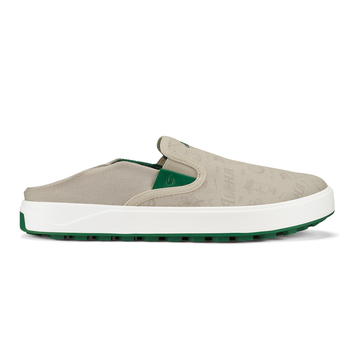 Beige canvas slip-on shoe with white midsole, green heel accent, and green rubber sole.