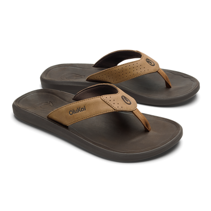 Two tan and dark brown thong sandals with perforated straps and cushioned soles, shown from a three-quarter angle.