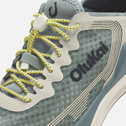Seagreen and white athletic shoe with yellow laces and "ōnki" branding on the side panel.