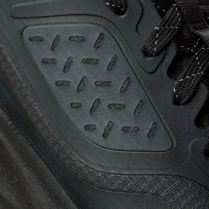 Gray hiking shoe with lava rock-patterned sole, black laces, and textured mesh upper.