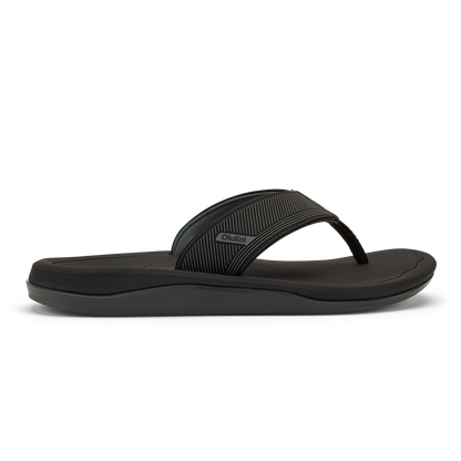 Black flip-flop sandal with textured strap and cushioned sole, shown in side profile.