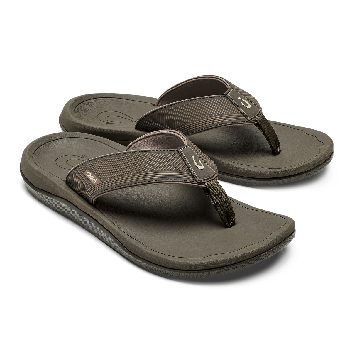 Pair of brown koa flip-flops with textured straps and cushioned soles, shown from a three-quarter view.