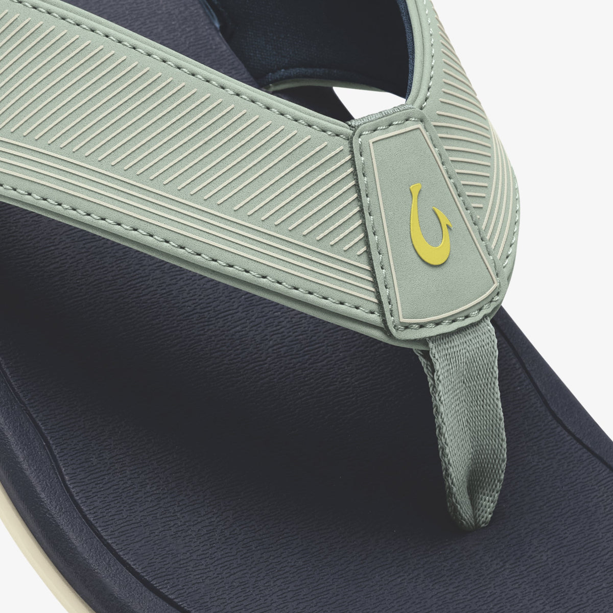 Seagreen and trench blue flip-flop with yellow hook logo detail on ribbed footbed strap.
