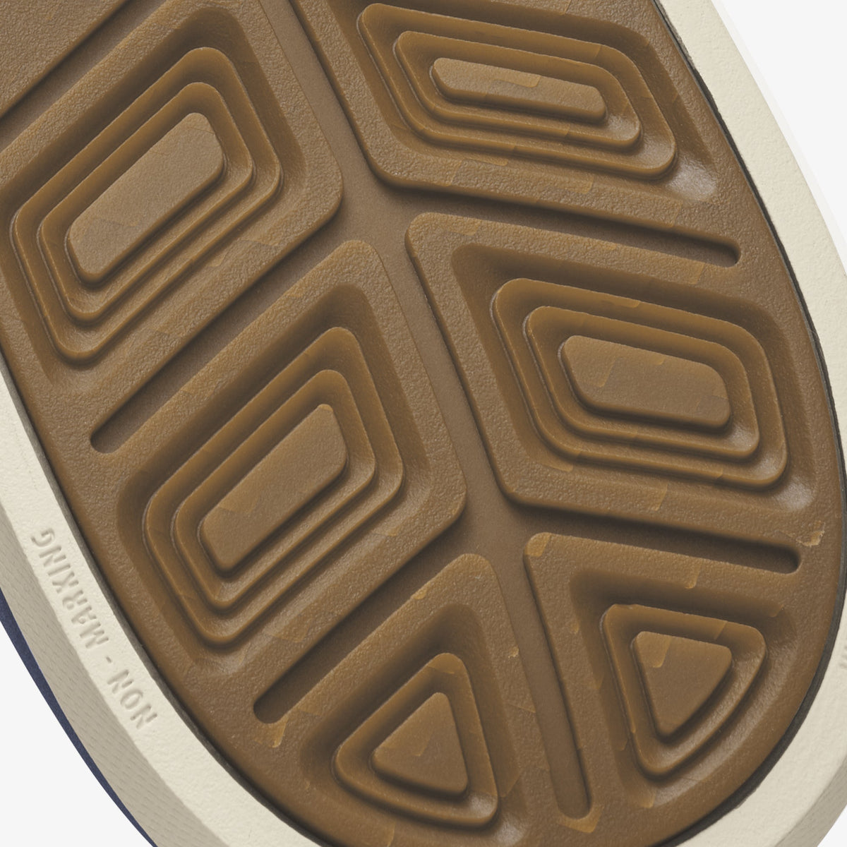 Shoe sole with tan rubber tread pattern and white edge trim.