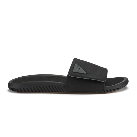 Black slide sandal with textured sole and adjustable padded strap across the foot.