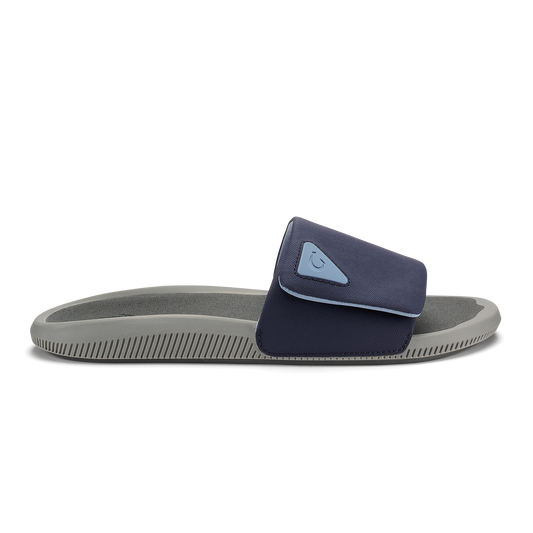 Blue and charcoal slide sandal with gray sole and textured footbed.