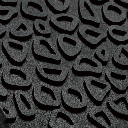 Dark gray textured surface with repeating curved cutout pattern and shadow details.