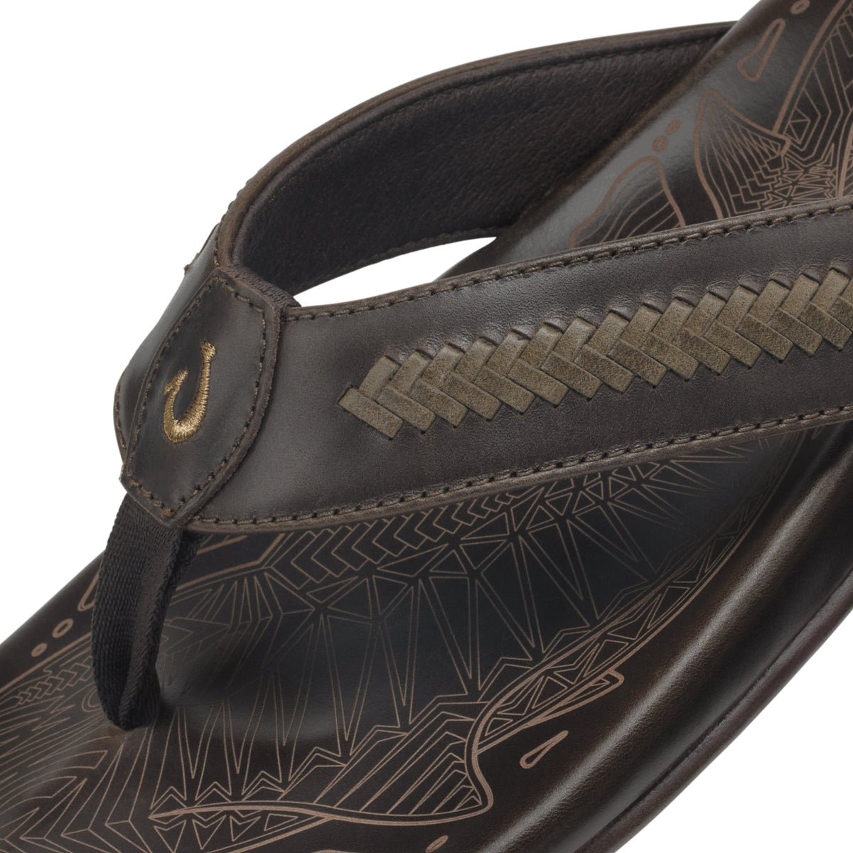 Dark brown leather thong sandal with geometric patterned footbed and woven strap detail.
