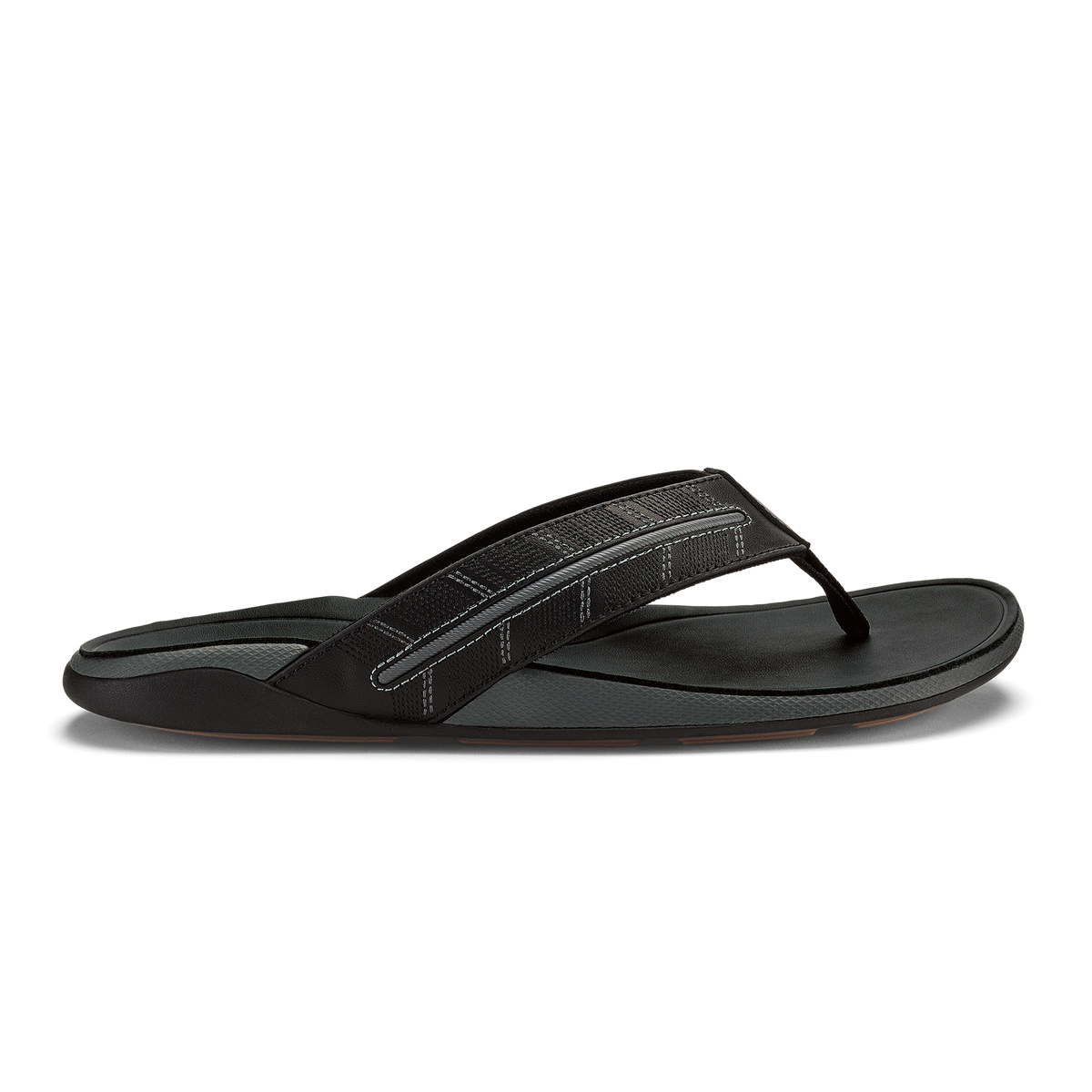 Black thong sandal with textured upper strap and flat sole, shown in profile view.