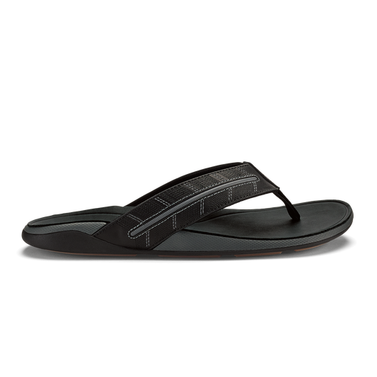 Black thong sandal with textured upper strap and flat sole, shown in profile view.