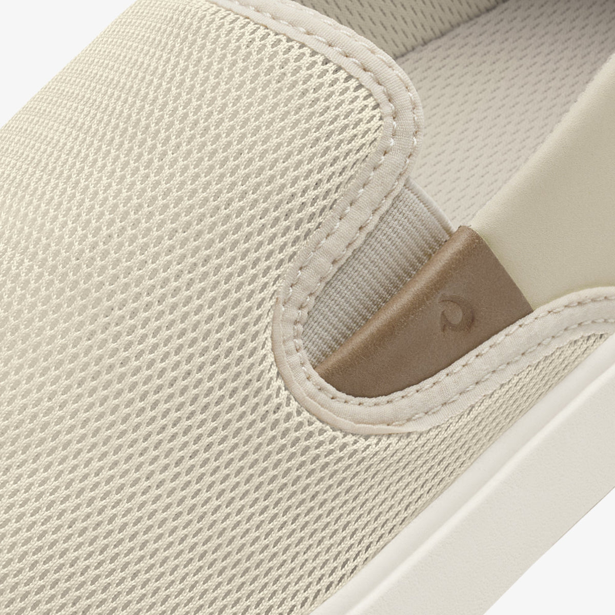 Cream and tan slip-on shoe with textured knit upper and stitched heel detail.