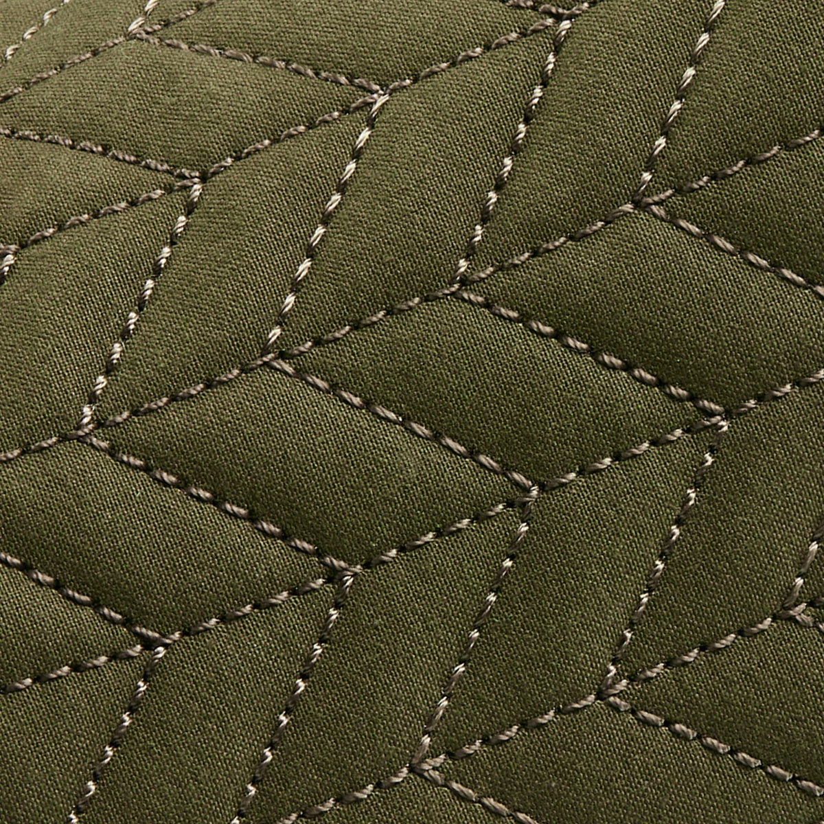 Olive green quilted fabric with cream-colored stitched diamond pattern detail.