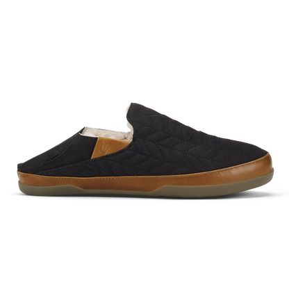 Black quilted mule slipper with tan leather trim and beige fleece lining.