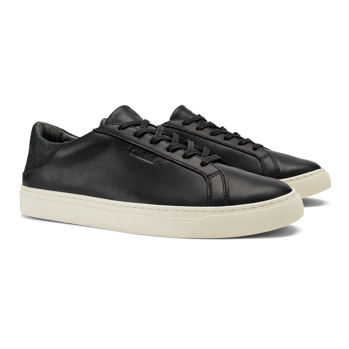 Black leather lace-up sneaker with cream rubber sole and textured heel panel.