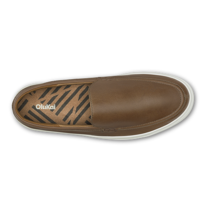 Walnut leather slip-on shoe with zebra stripe patterned insole and white sole, top view.