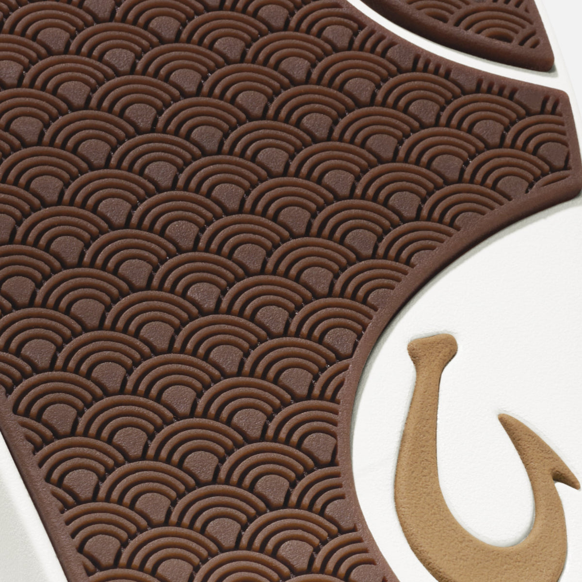 Brown sole with geometric scallop pattern and tan fish hook detail.