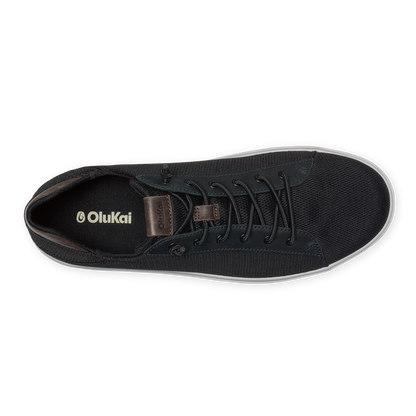 Black lace-up sneaker with textured canvas upper, brown leather heel tab, and white sole, shown from above.