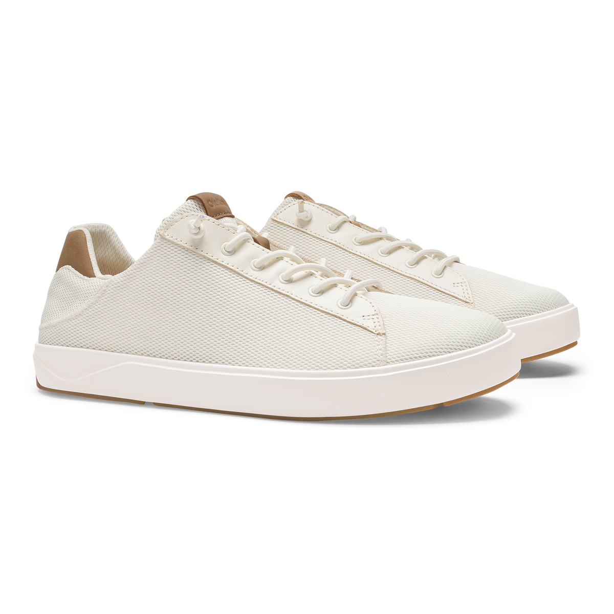 White lace-up sneaker with textured mesh upper, white sole, and tan heel tab.