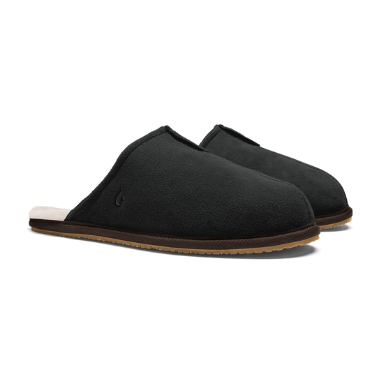 Black suede slippers with tan sole and cream fleece lining, shown from the side.