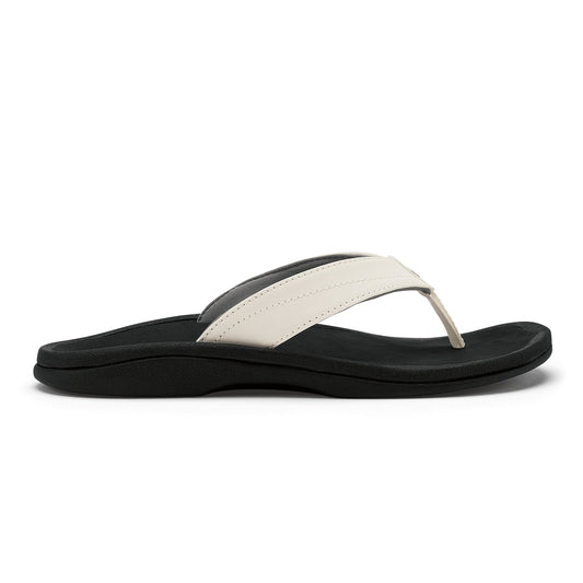 White and black thong sandal with black foam sole and cushioned footbed.