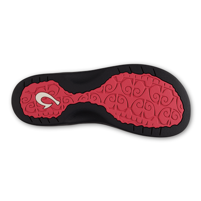 Shoe sole with hot pink and black rubber tread pattern featuring white logo detail.