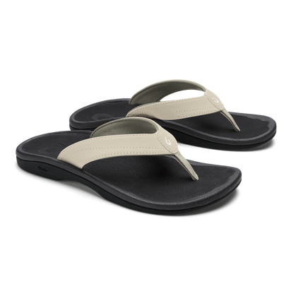 Pair of ecru and black flip-flop sandals with cushioned black soles and thong straps.