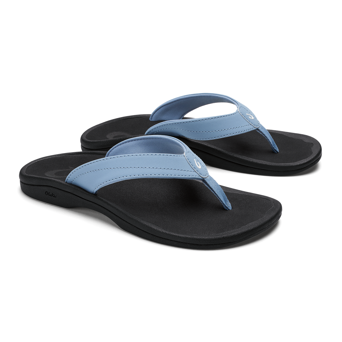 Pair of flip-flops with light blue straps and black soles, shown from a three-quarter view.