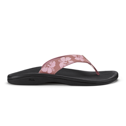 Coral rose flip-flop sandal with black sole and floral patterned upper strap.