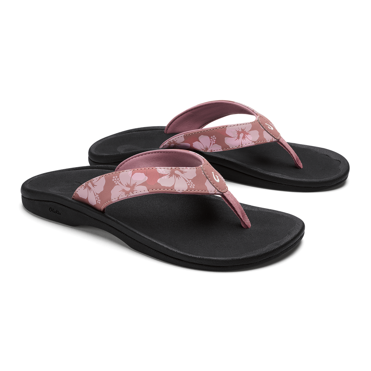 Pair of coral rose flip-flops with black soles and floral-patterned straps.