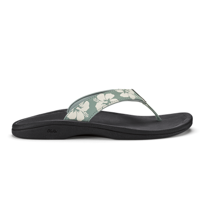 Thong sandal with silver-green floral printed strap and black cushioned footbed.