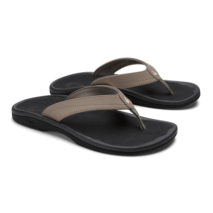 Pair of thong sandals with warm taupe straps and black cushioned footbeds.