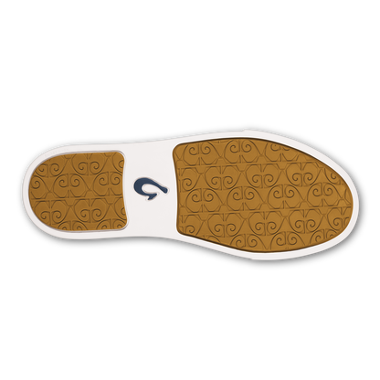 Shoe sole view showing tan patterned rubber outsole with white midsole and navy brand logo.