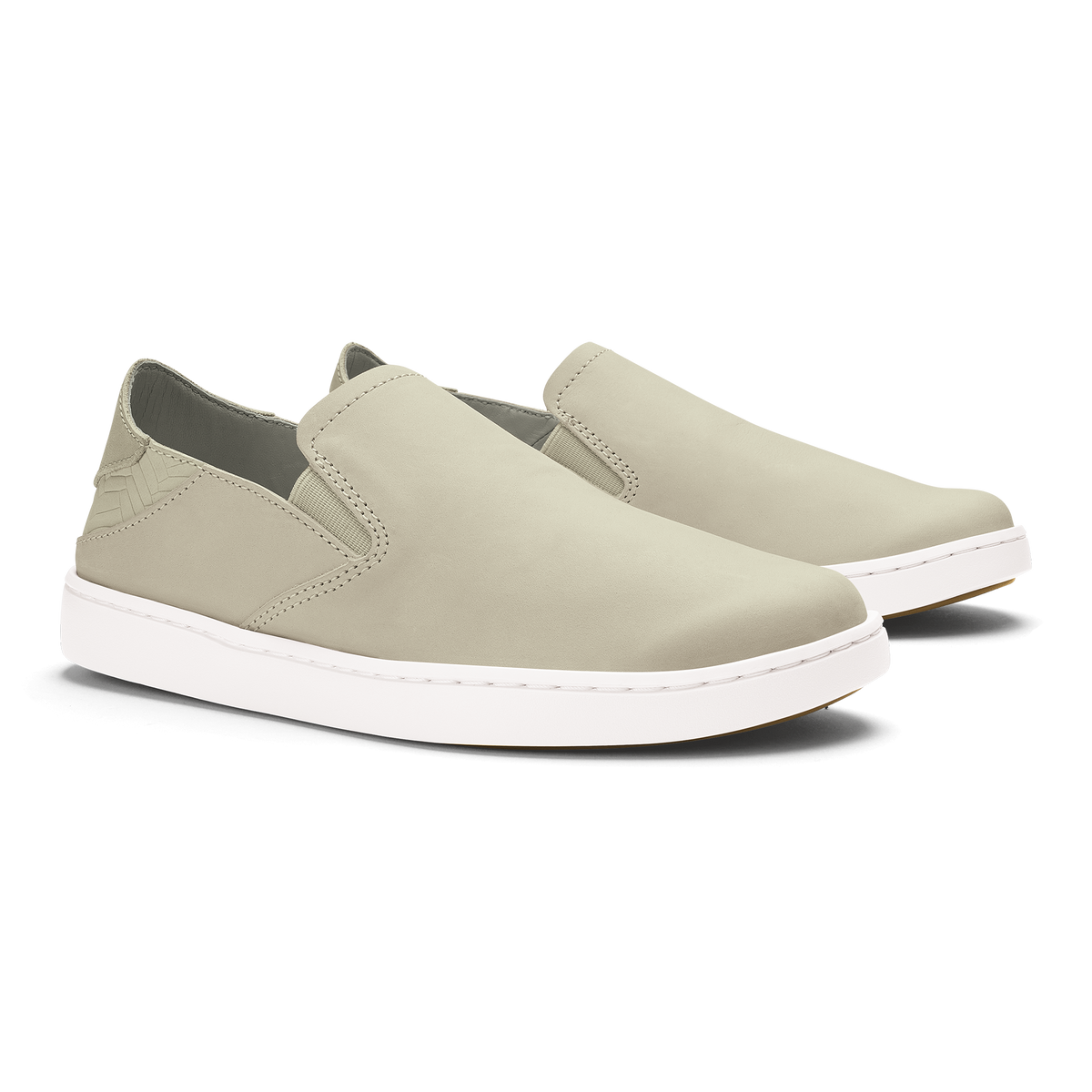 Beige leather slip-on sneakers with white sole and stitched detailing, shown from a three-quarter angle.