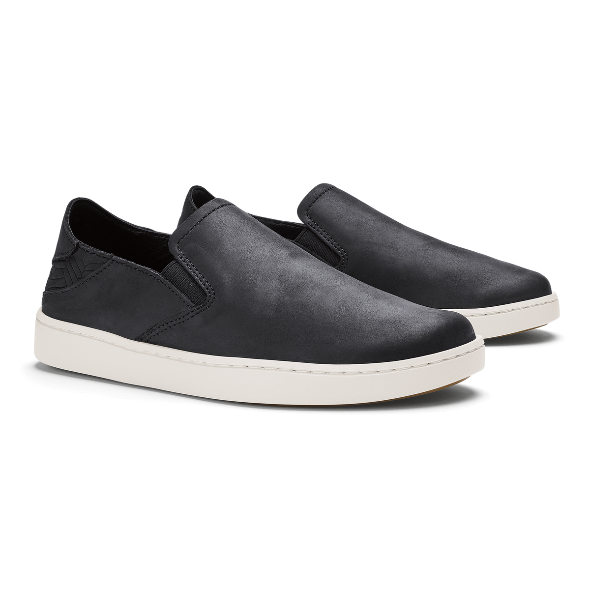Black leather slip-on shoes with white rubber soles, shown as a pair from the side.